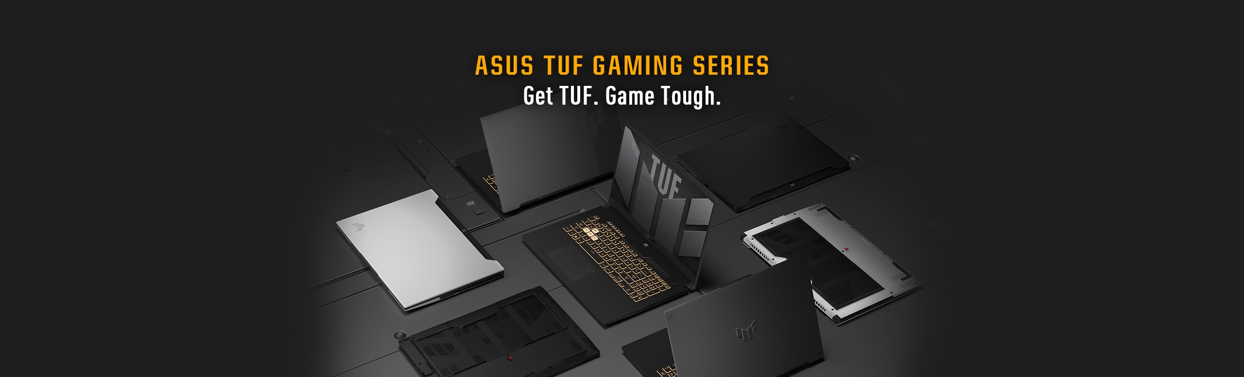 Laptopuri de diferite culori, din Seria ASUS TUF GAMING SERIES,  așezate pe un fundal întunecat, cu capacul inchis sau cu spatele in sus, in jurul unui laptop TUF deschis.