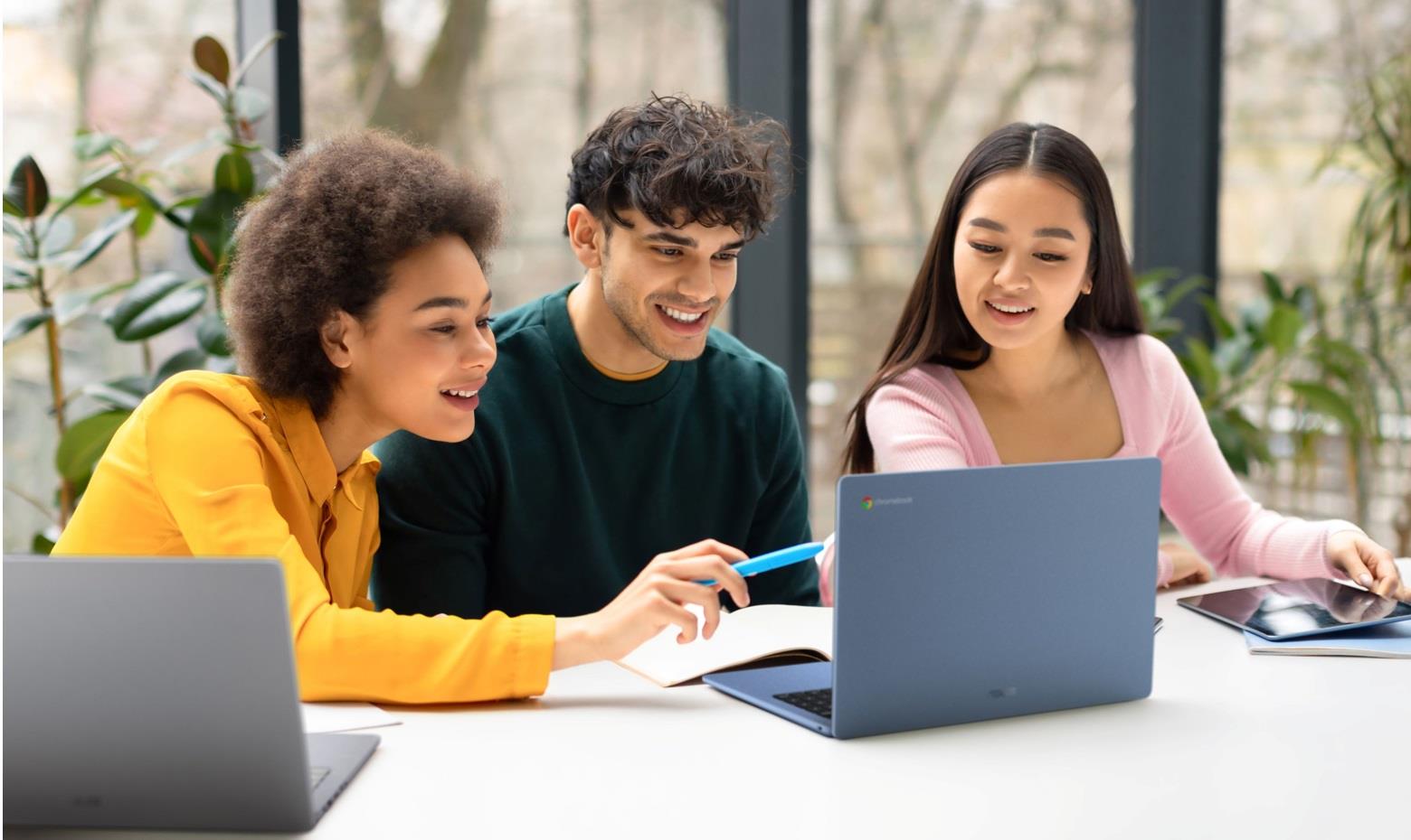 Three people collaborate on a project using an ASUS laptop