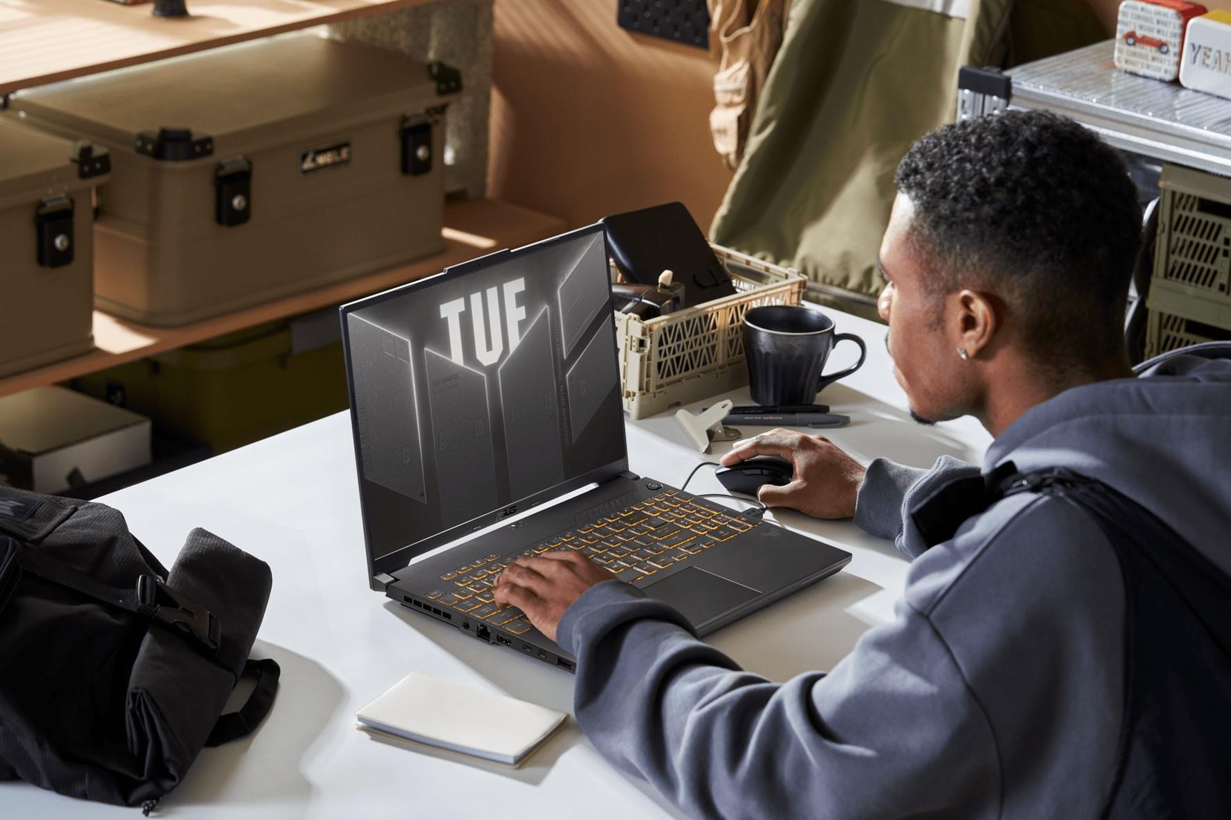 A person sitting at a desk with a TUF Gaming F16