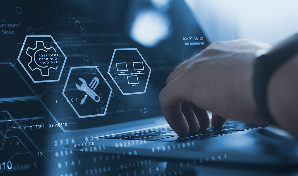 Person’s hand typing on a laptop keyboard with digital graphics of gears and tools overlayed, illustrating Out-of-band Management (OOB) on ASUS CSM motherboards for remote device access, monitoring, and troubleshooting of unresponsive systems